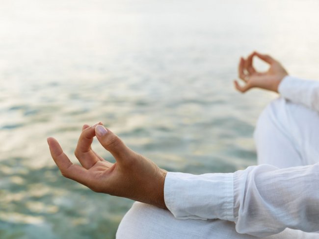 Woman practicing yoga at sunrise